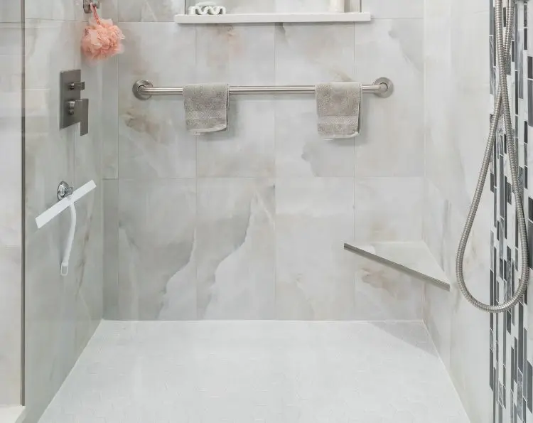 Light gray marble shower with gray metal fixtures