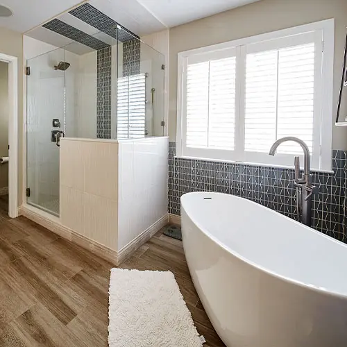 Fully remodeled bathroom with wooden floors and plantation shutters