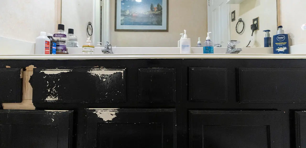 Black vanity with peeling paint 