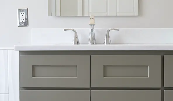 Taupe vanity with white sink and silver fixtures